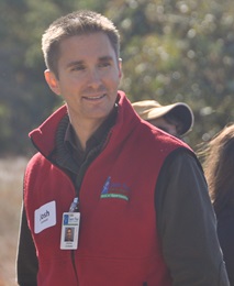 Josh's portrait shows him outdoors, wearing a red vest