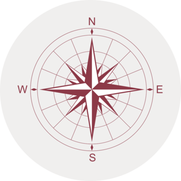 Gray circular icon with an illustrated compass face showing North, South, West and East.